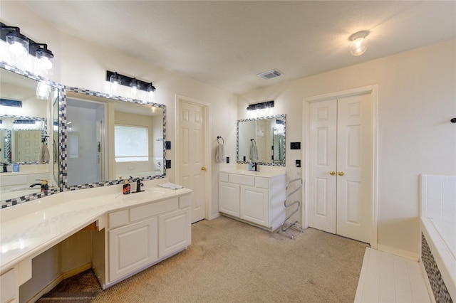 1635 Pebble Banks, Pasadena, TX 77586 - bathroom with two vanities and a relaxing tiled tub