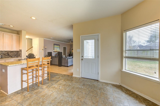 1635 Pebble Banks, Pasadena, TX 77586 - kitchen featuring a kitchen breakfast bar, backsplash, light stone countertops, recessed lighting, and open floor plan