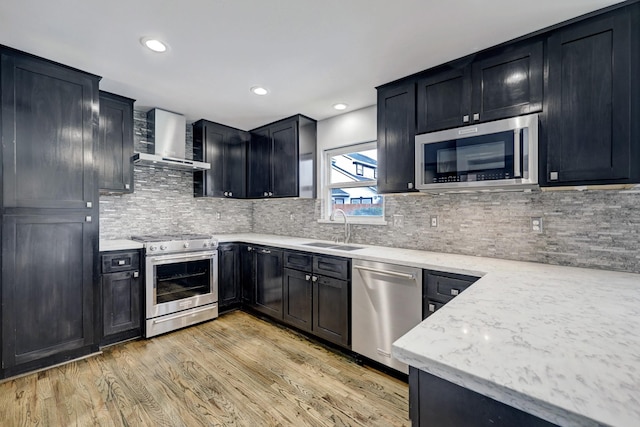 3307 Chris Dr, Houston, TX 77063 - kitchen with stainless steel appliances, wall chimney range hood, a sink, dark cabinets, and recessed lighting