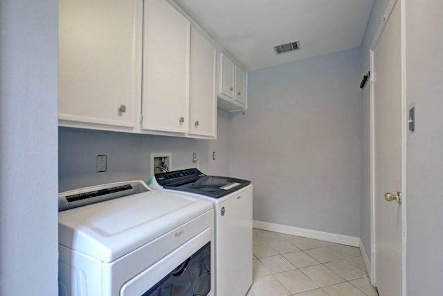 3307 Chris Dr, Houston, TX 77063 - laundry area with cabinet space, washer and clothes dryer, light tile patterned floors, and baseboards