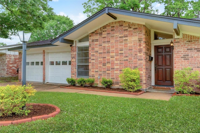 5810 Verdome Ln, Houston, TX 77092 - entrance to property with brick siding, an attached garage, and a yard