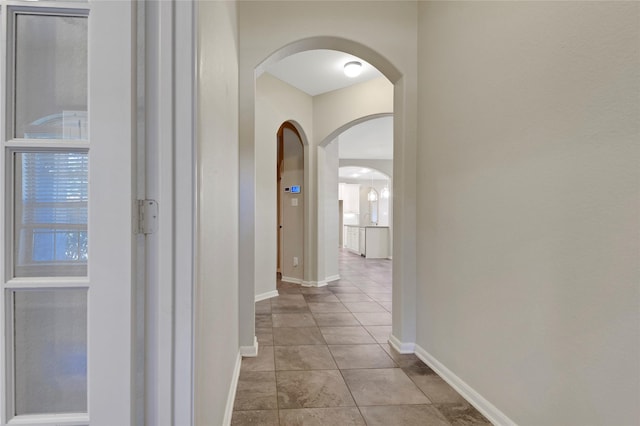 19219 S Cottonwood Green Ln, Cypress, TX 77433 - corridor with arched walkways, baseboards, and tile patterned flooring