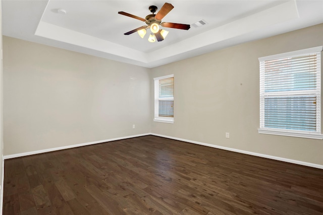 19219 S Cottonwood Green Ln, Cypress, TX 77433 - spare room with a raised ceiling, baseboards, dark wood-type flooring, and ceiling fan
