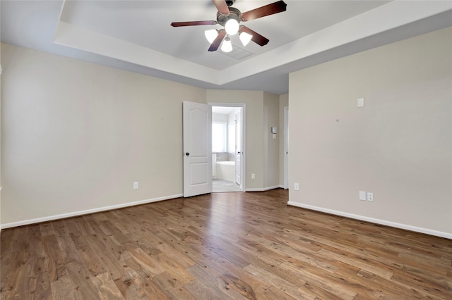 19219 S Cottonwood Green Ln, Cypress, TX 77433 - spare room with a raised ceiling, a ceiling fan, baseboards, and wood finished floors
