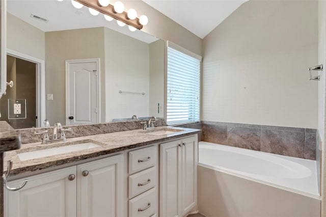 19219 S Cottonwood Green Ln, Cypress, TX 77433 - bathroom with lofted ceiling, a garden tub, and double vanity