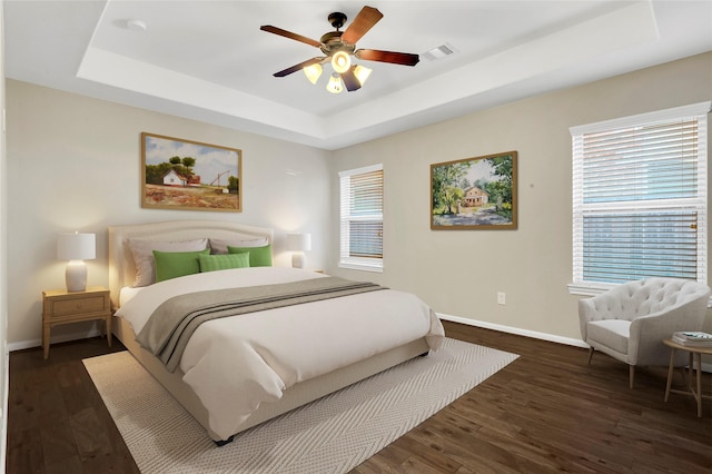 19219 S Cottonwood Green Ln, Cypress, TX 77433 - bedroom with a tray ceiling, baseboards, and dark wood finished floors