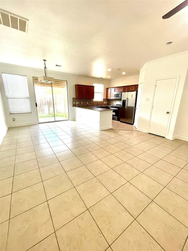 13150 Lawsons Creek Ln, Houston, TX 77072 - kitchen with appliances with stainless steel finishes, open floor plan, dark countertops, backsplash, and light tile patterned flooring