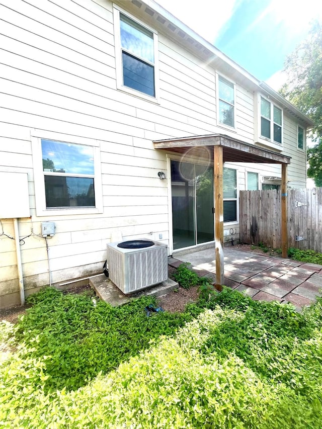 13150 Lawsons Creek Ln, Houston, TX 77072 - back of property featuring central AC and a patio