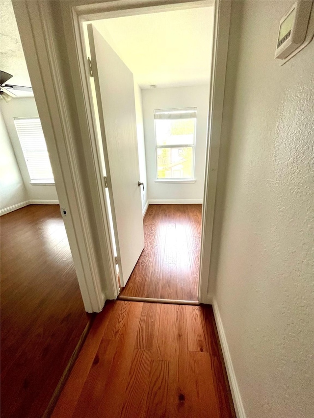 13150 Lawsons Creek Ln, Houston, TX 77072 - hallway featuring wood finished floors, baseboards, and a textured wall