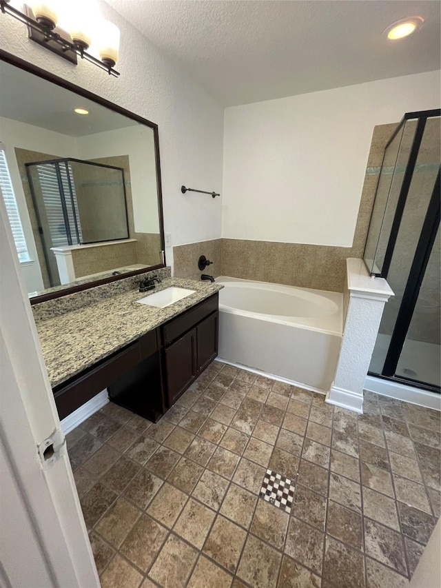 13150 Lawsons Creek Ln, Houston, TX 77072 - bathroom with a stall shower, a bath, vanity, stone tile flooring, and a textured ceiling