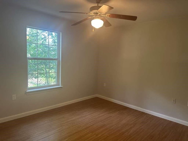 3418 Memel St, Houston, TX 77026 - spare room featuring healthy amount of natural light, dark wood-style floors, and baseboards