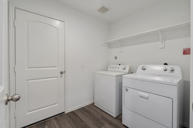 laundry area with washer and dryer and dark wood-style floors