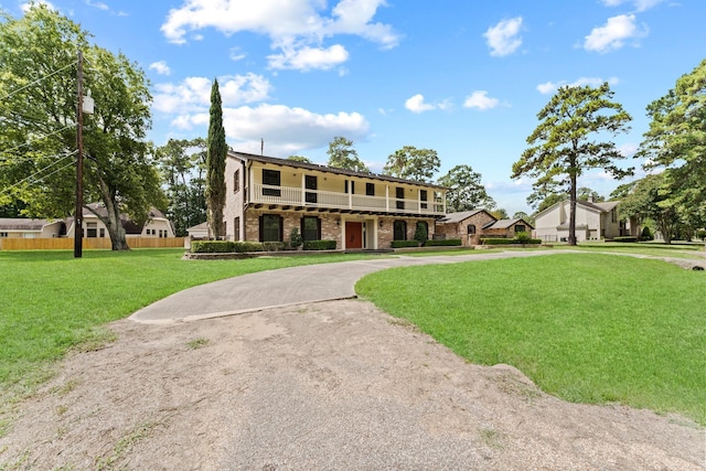 3310 Riviera Ln, Houston, TX 77338 - view of front of home featuring curved driveway, brick siding, and a balcony
