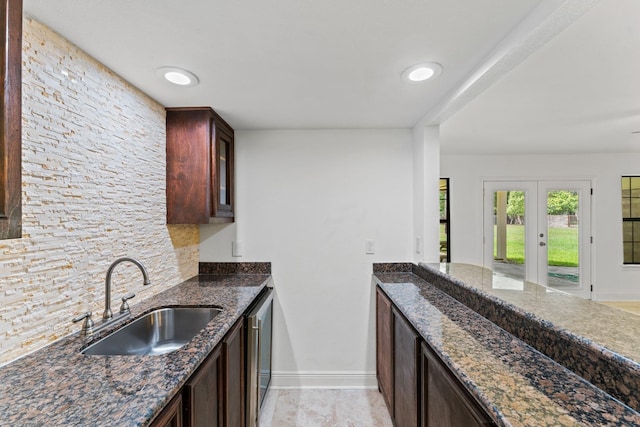 3310 Riviera Ln, Houston, TX 77338 - kitchen with a sink, baseboards, dishwasher, dark stone counters, and french doors