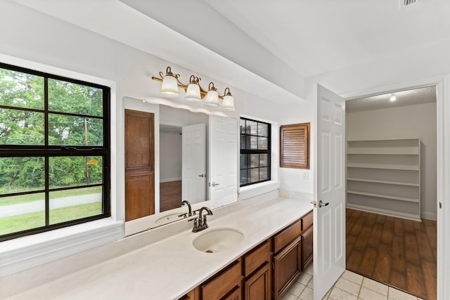 3310 Riviera Ln, Houston, TX 77338 - bathroom with healthy amount of natural light, vanity, tile patterned flooring, and baseboards