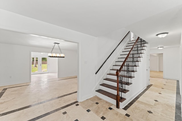 3310 Riviera Ln, Houston, TX 77338 - staircase featuring baseboards, inlaid floor details, and a chandelier