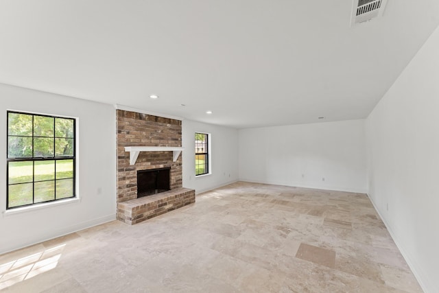 3310 Riviera Ln, Houston, TX 77338 - unfurnished living room with a brick fireplace, baseboards, stone finish floors, and recessed lighting
