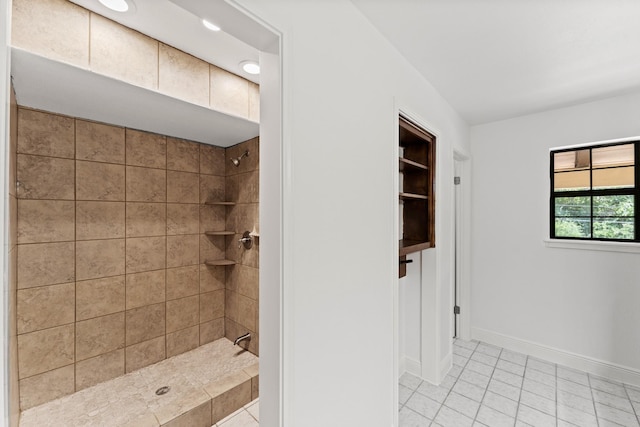 3310 Riviera Ln, Houston, TX 77338 - bathroom with tiled shower, tile patterned flooring, and baseboards