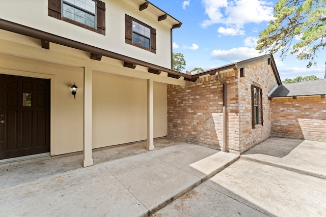 3310 Riviera Ln, Houston, TX 77338 - doorway to property featuring brick siding and a patio area
