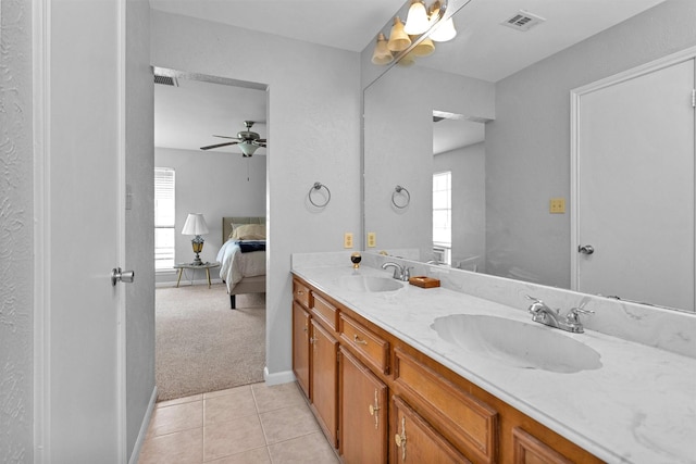 445 Augusta Dr, Huntsville, TX 77340 - ensuite bathroom featuring ceiling fan, double vanity, tile patterned flooring, and baseboards