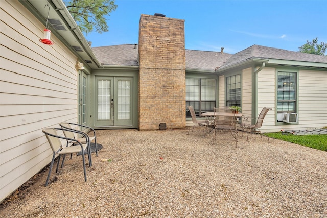 445 Augusta Dr, Huntsville, TX 77340 - rear view of property with a chimney, roof with shingles, a patio area, french doors, and cooling unit