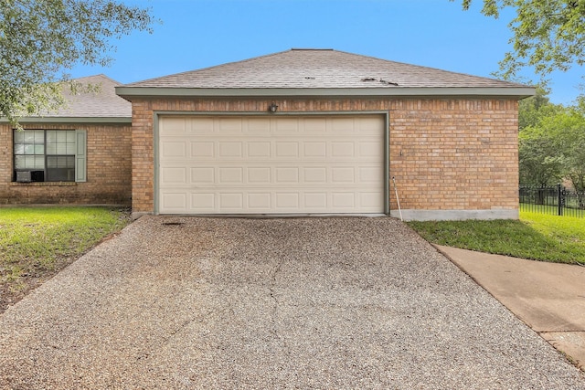 445 Augusta Dr, Huntsville, TX 77340 - garage featuring driveway and fence