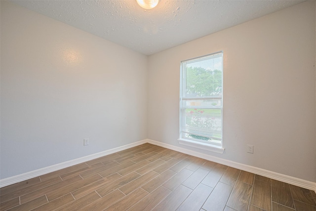 20101 Dawn Mist Dr, Humble, TX 77346 - empty room with baseboards, wood finished floors, and a textured ceiling