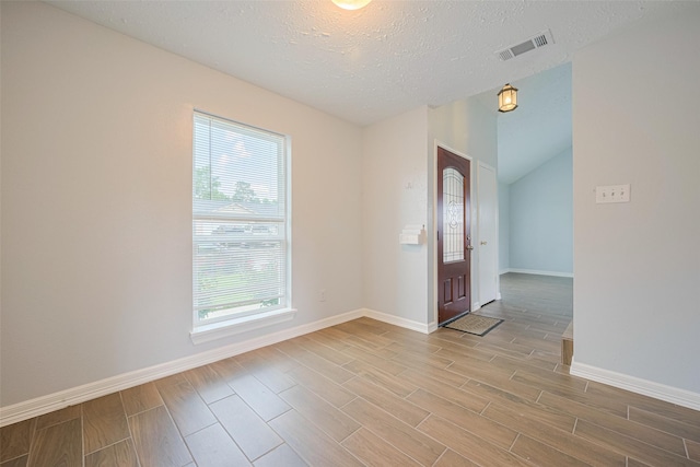 20101 Dawn Mist Dr, Humble, TX 77346 - spare room featuring wood finished floors, baseboards, a textured ceiling, and vaulted ceiling