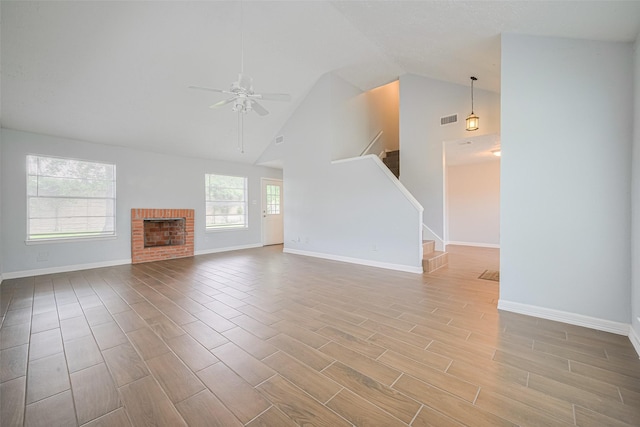 20101 Dawn Mist Dr, Humble, TX 77346 - unfurnished living room featuring ceiling fan, stairway, baseboards, wood finished floors, and high vaulted ceiling