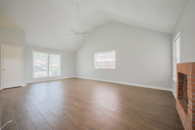 20101 Dawn Mist Dr, Humble, TX 77346 - unfurnished living room with ceiling fan, lofted ceiling, wood finish floors, baseboards, and a textured ceiling