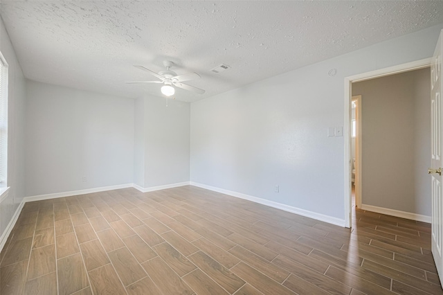 20101 Dawn Mist Dr, Humble, TX 77346 - spare room featuring a ceiling fan, wood finished floors, a textured ceiling, and baseboards