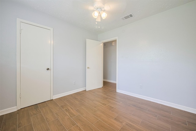 20101 Dawn Mist Dr, Humble, TX 77346 - unfurnished bedroom with wood finish floors, baseboards, and a ceiling fan