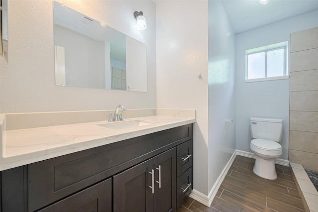 20101 Dawn Mist Dr, Humble, TX 77346 - bathroom with toilet, wood finish floors, vanity, and baseboards