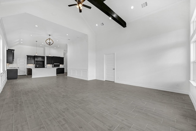 318 Little Spring Ct, Anahuac, TX 77523 - unfurnished living room with high vaulted ceiling, a ceiling fan, beam ceiling, recessed lighting, and a decorative wall