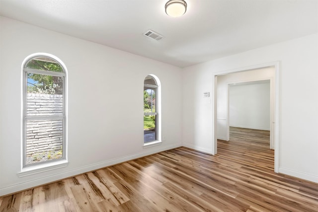 2407 Del Norte St, Houston, TX 77018 - spare room with light wood-style floors, baseboards, and arched walkways