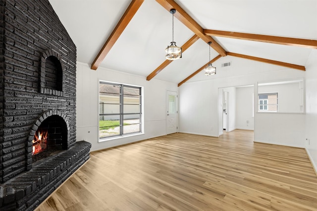 2407 Del Norte St, Houston, TX 77018 - unfurnished living room featuring wood finished floors, a brick fireplace, baseboards, and a chandelier