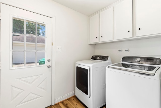 2407 Del Norte St, Houston, TX 77018 - washroom featuring separate washer and dryer, cabinet space, light wood finished floors, and baseboards
