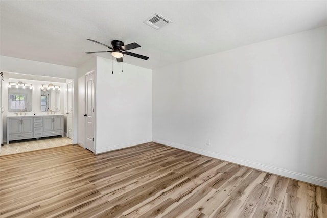 2407 Del Norte St, Houston, TX 77018 - unfurnished bedroom featuring light wood-type flooring, baseboards, a sink, connected bathroom, and a ceiling fan