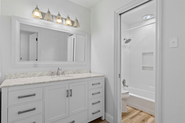 2407 Del Norte St, Houston, TX 77018 - bathroom featuring toilet, vanity, wood finished floors, and shower / bath combination