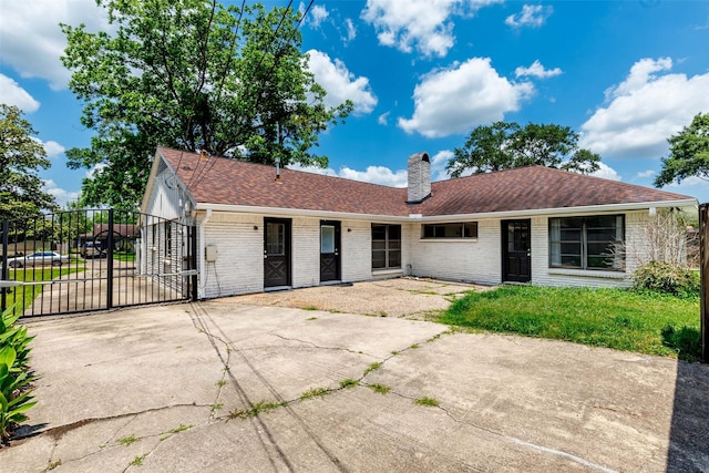 2407 Del Norte St, Houston, TX 77018 - rear view of property with a gate, brick siding, a chimney, fence, and concrete driveway
