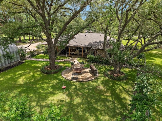 12392 Fm 355, Trinity, TX 75862 - view of green lawn featuring a fire pit and a patio