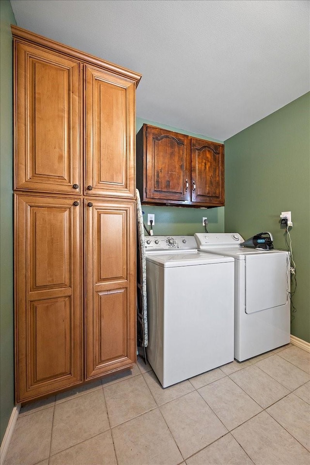 12392 Fm 355, Trinity, TX 75862 - laundry room featuring cabinet space, washing machine and clothes dryer, light tile patterned floors, and baseboards