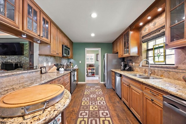 12392 Fm 355, Trinity, TX 75862 - kitchen with stainless steel appliances, a sink, dark wood-style floors, baseboards, and light stone countertops
