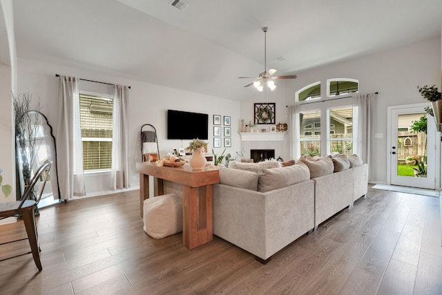 8619 Morning Dove Ln, Baytown, TX 77521 - living room with ceiling fan, wood finished floors, a fireplace, plenty of natural light, and vaulted ceiling