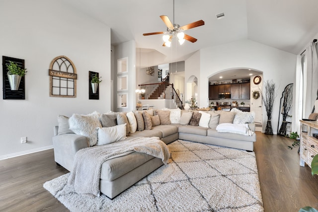 8619 Morning Dove Ln, Baytown, TX 77521 - living area featuring arched walkways, ceiling fan, dark wood finished floors, baseboards, and high vaulted ceiling