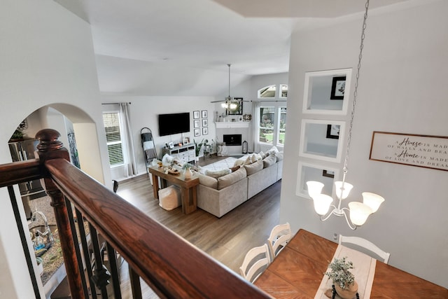 8619 Morning Dove Ln, Baytown, TX 77521 - living room with lofted ceiling, wood finished floors, ceiling fan, and a chandelier