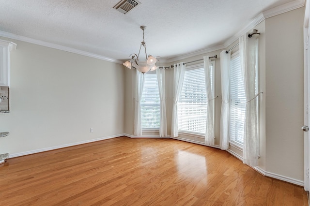 341 Sam, Houston Loop, Point Blank, TX 77364 - spare room featuring a chandelier, ornamental molding, light wood-style floors, healthy amount of natural light, and baseboards