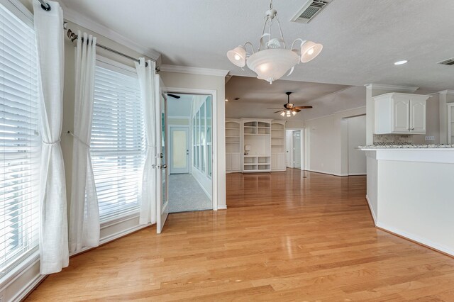 341 Sam, Houston Loop, Point Blank, TX 77364 - unfurnished dining area with ceiling fan, light wood-style flooring, plenty of natural light, crown molding, and baseboards