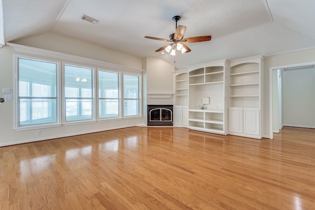341 Sam, Houston Loop, Point Blank, TX 77364 - unfurnished living room featuring vaulted ceiling, ceiling fan, light wood-type flooring, a fireplace, and baseboards
