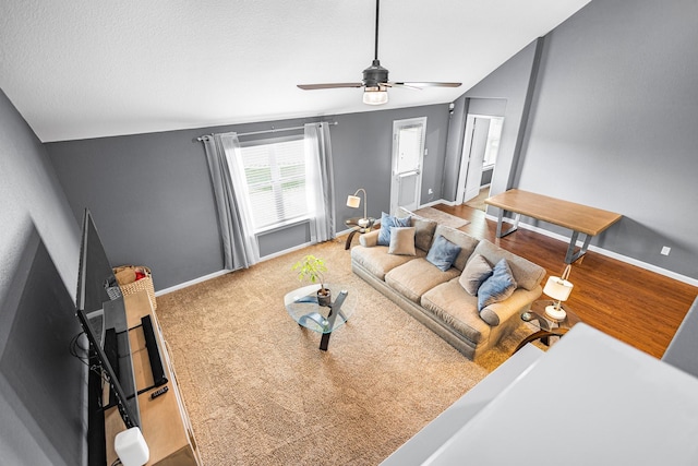 living area with ceiling fan and baseboards
